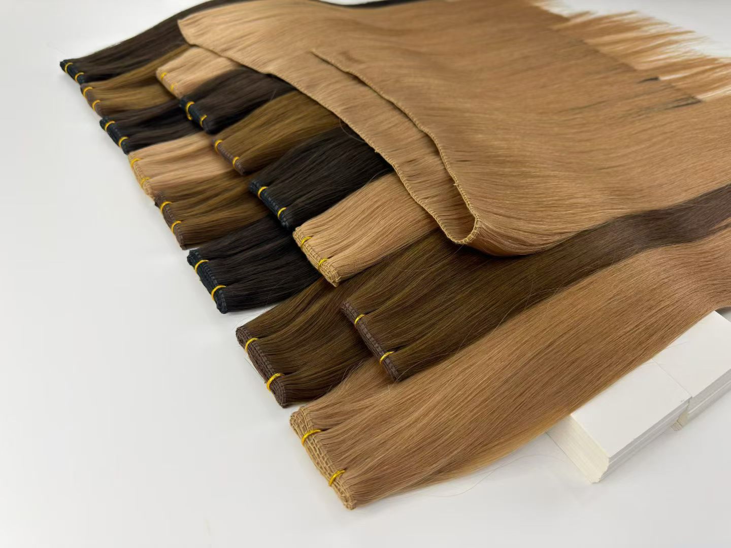 Natural-colour wefts arranged for material review