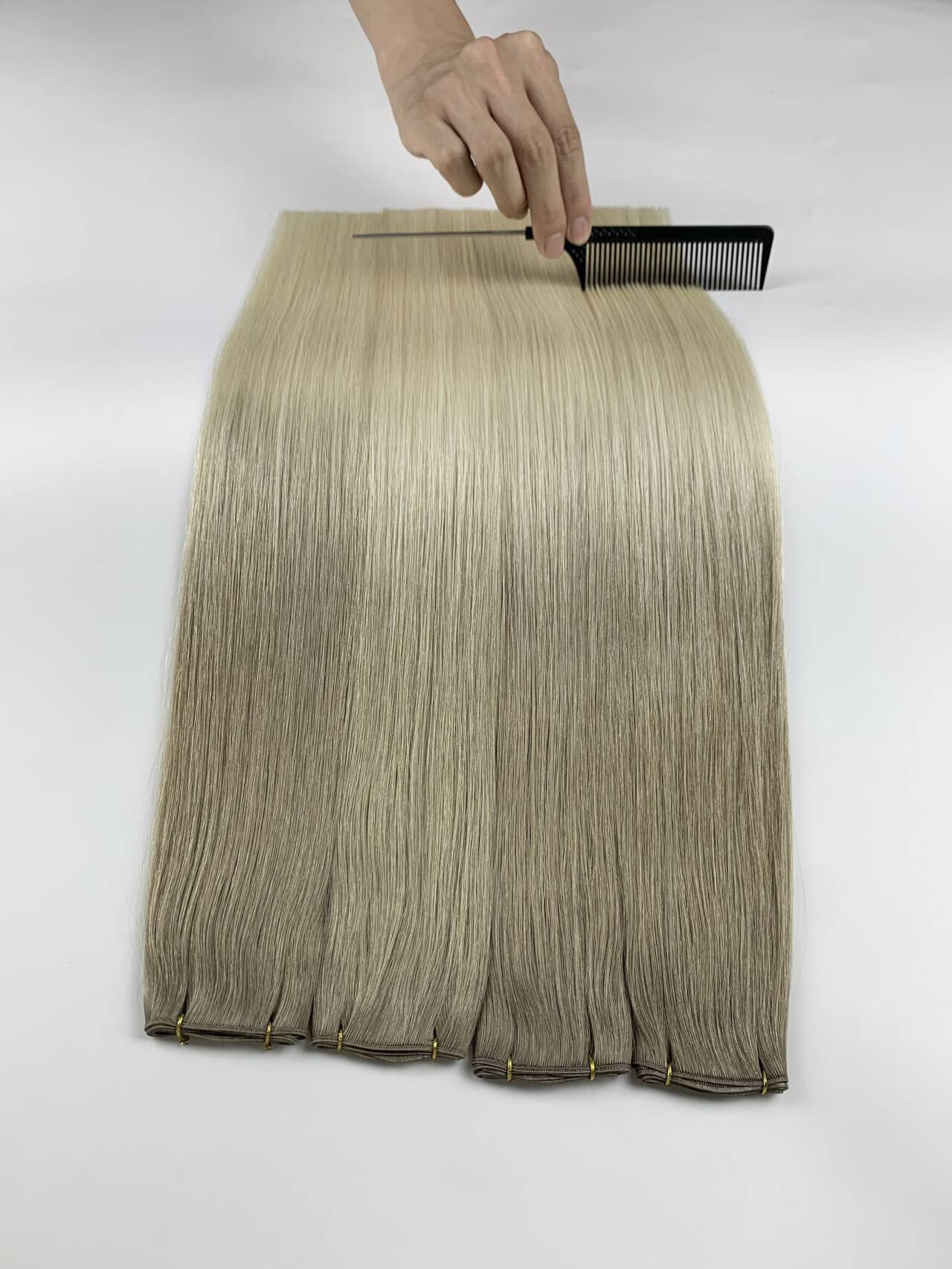 Hair being inspected and carefully combed during quality review